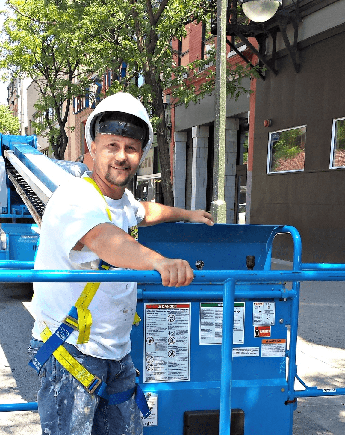 Forest City Painters employee in a lift at a job site in London, Ontario