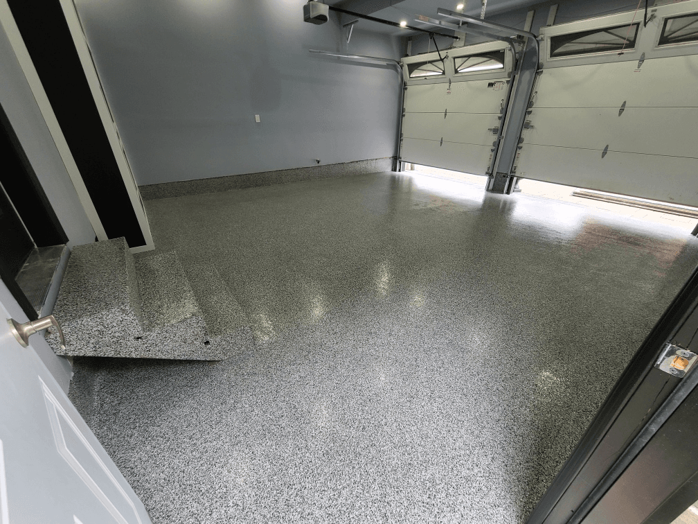 Freshly coated flake epoxy garage floor in a residential home in London, Ontario