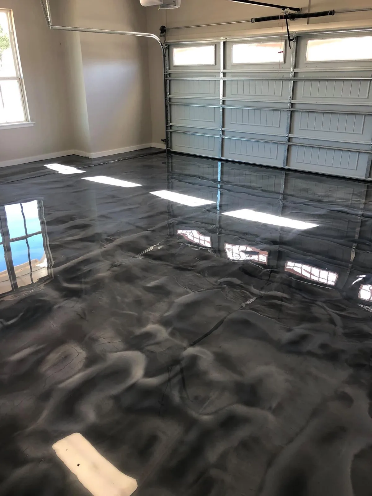 High-gloss metallic polymer floor coating finished in a two-car garage