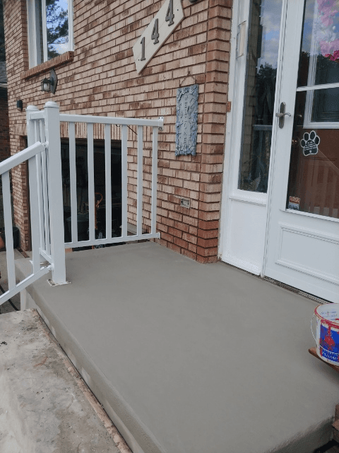 Freshly resurfaced front porch concrete steps and landing on a residential home in London, Ontario